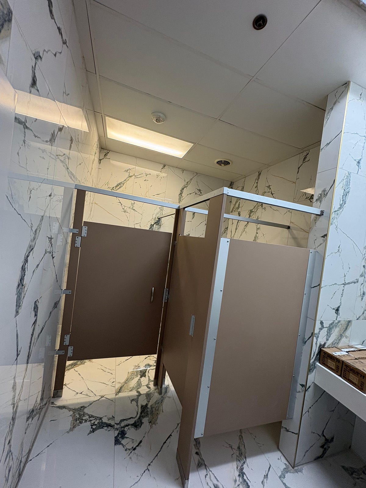 Solid plastic HDPE bathroom partitions in a high-traffic public facility